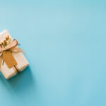 Craft paper gift boxs set on blue background with copy space for text.